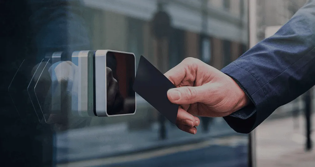Access card tapped on a door reader at a commercial entrance — access control installation Perth