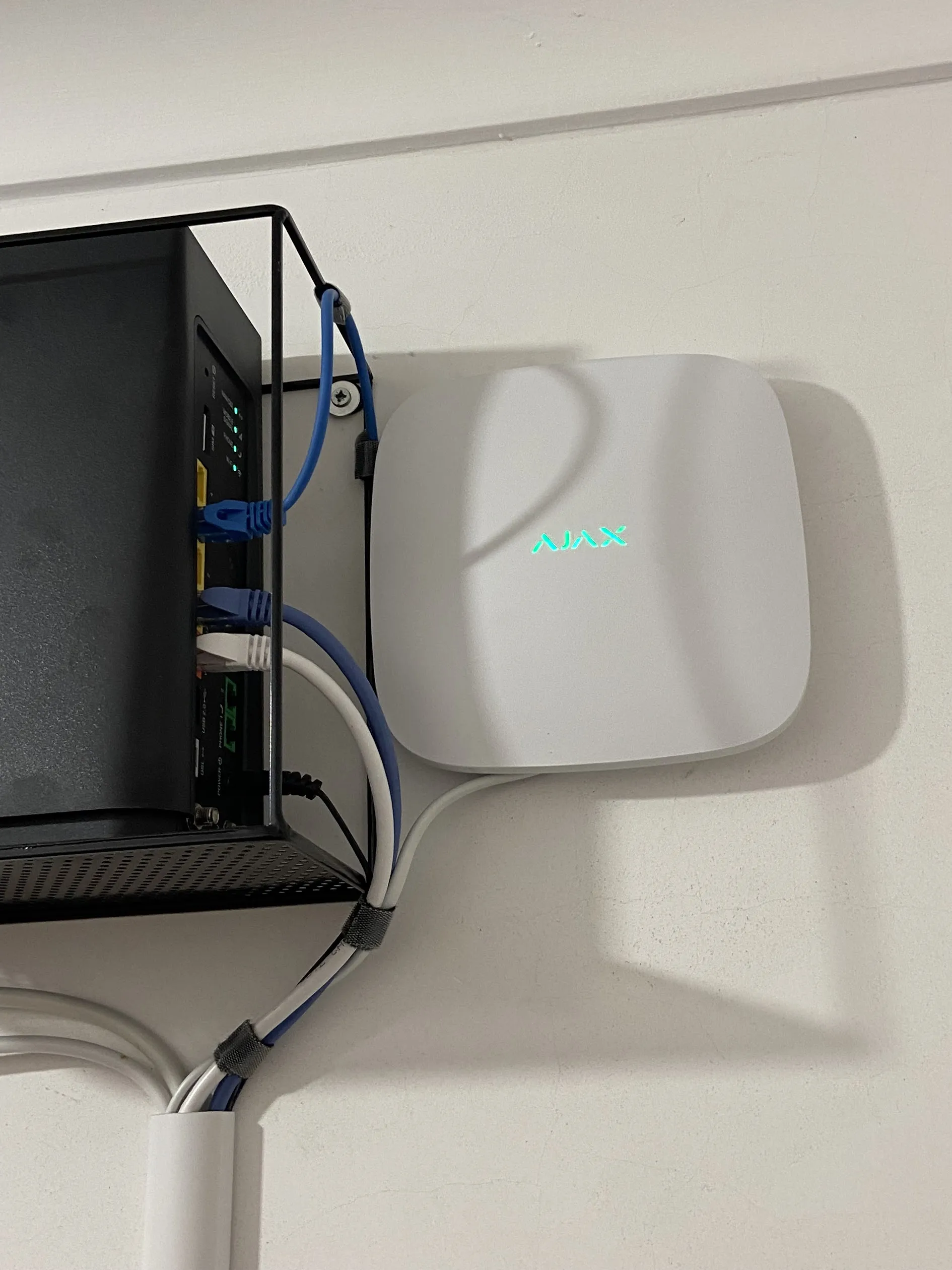 Ajax Hub alarm panel installed beside the network router at a Perth property