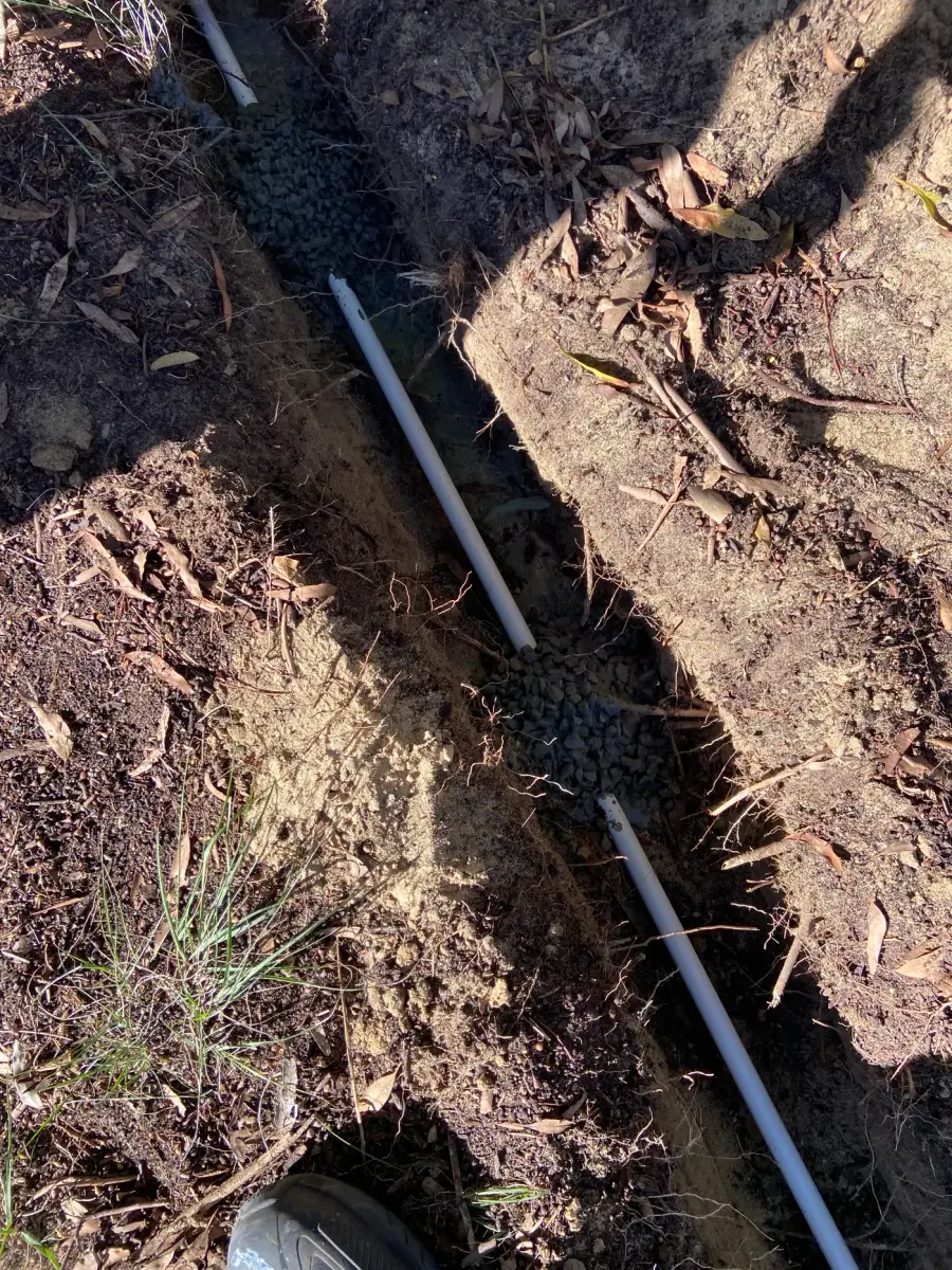 Trenched conduit run carrying camera cabling from a pole back to the building on a Perth installation