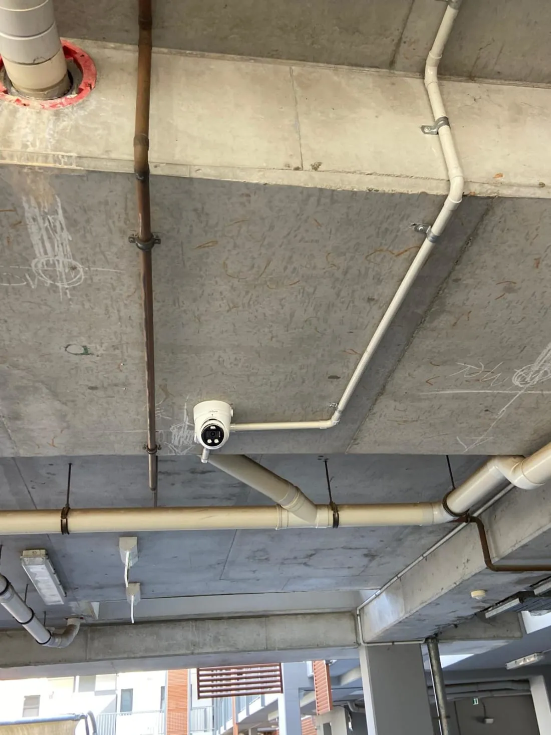 Camera and tidy conduit run on the ceiling of an underground car park