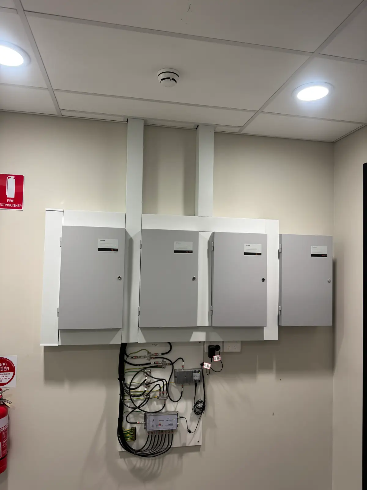 Genetec installer Perth: bank of security and access controllers in a plant room at a Perth commercial site