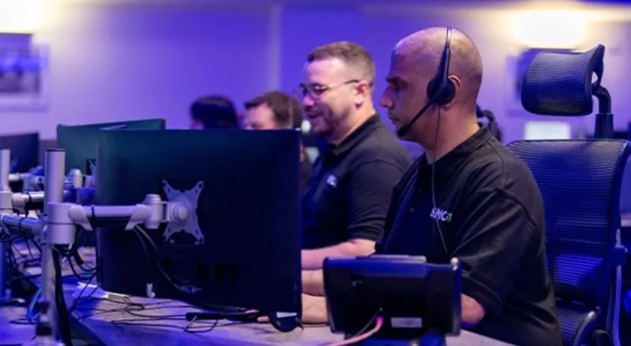Operators at monitoring workstations in a professional alarm control room