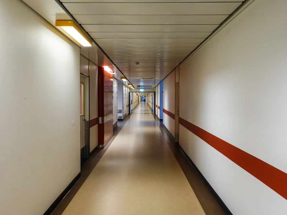Clean, modern hospital corridor with doors along both sides