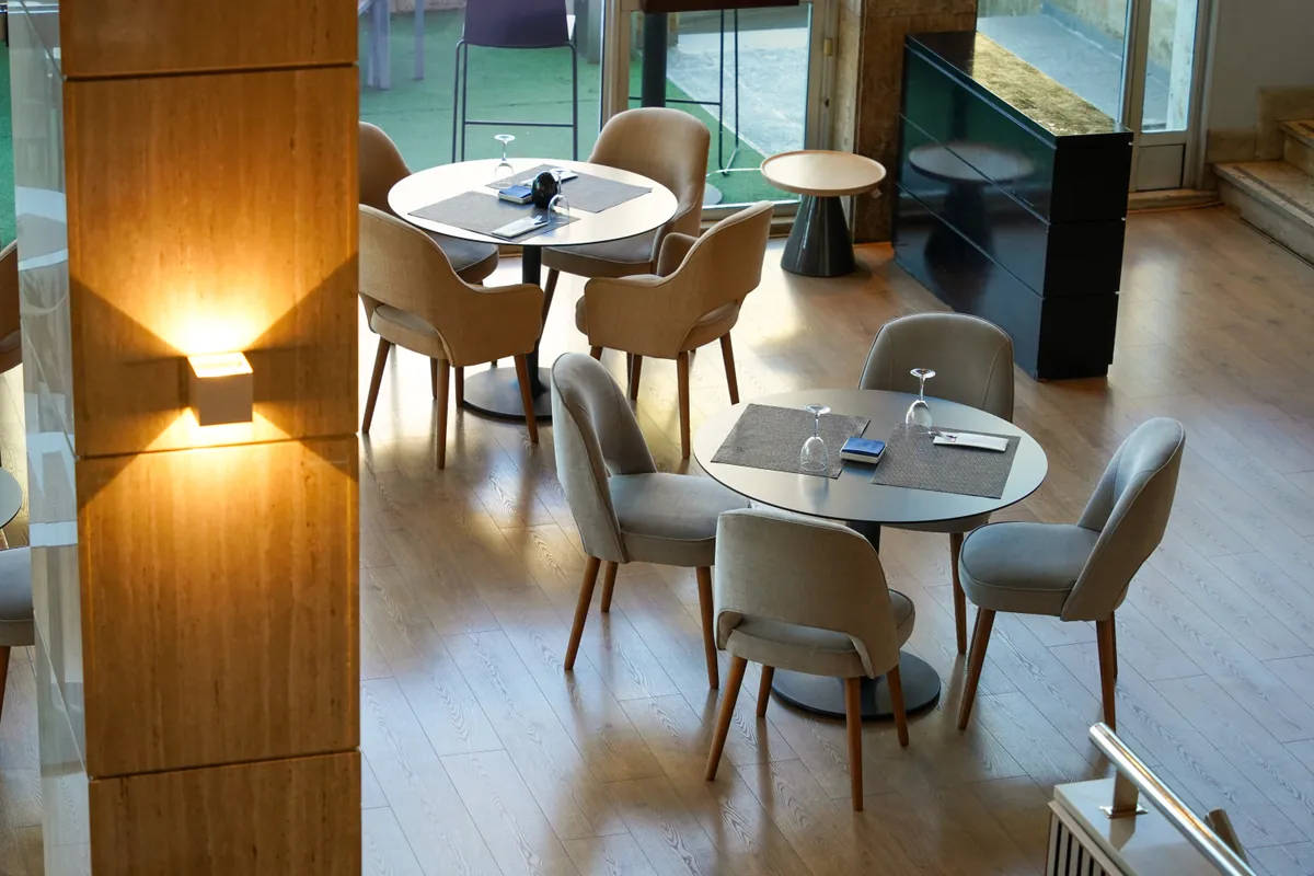 Modern restaurant dining room with set tables and natural light
