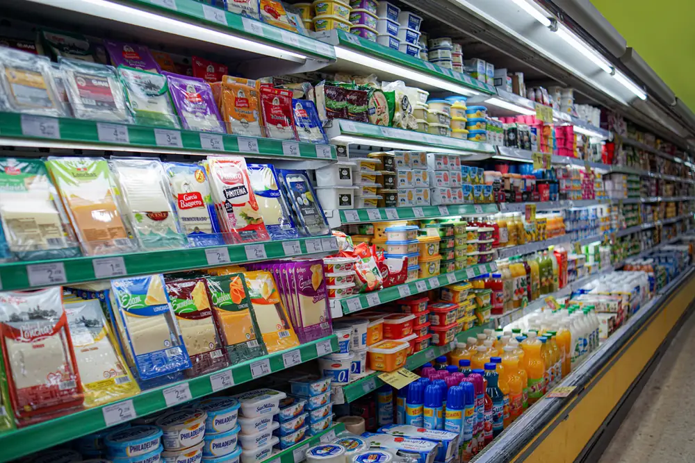 Well-lit supermarket aisle with fully stocked shelves in a retail store