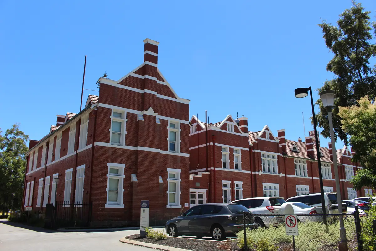 Heritage red-brick school building in Perth on a clear day