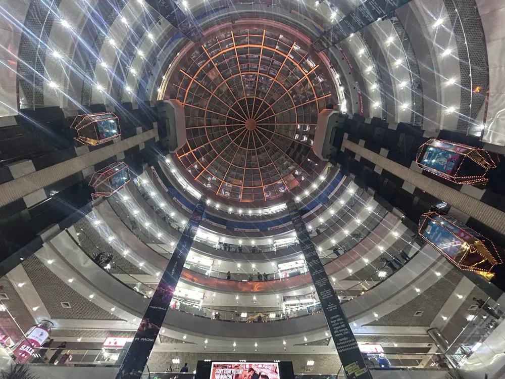 Multi-level shopping centre atrium viewed from the ground floor