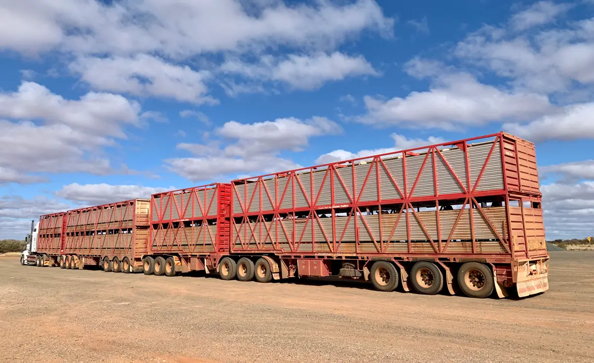 Road train parked at an outback Australian depot under a blue sky